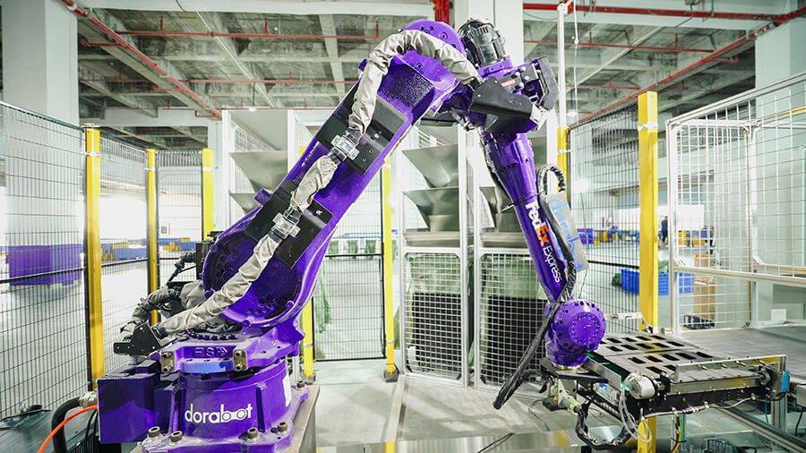 Purple AI sorting robot at FedEx sorting center