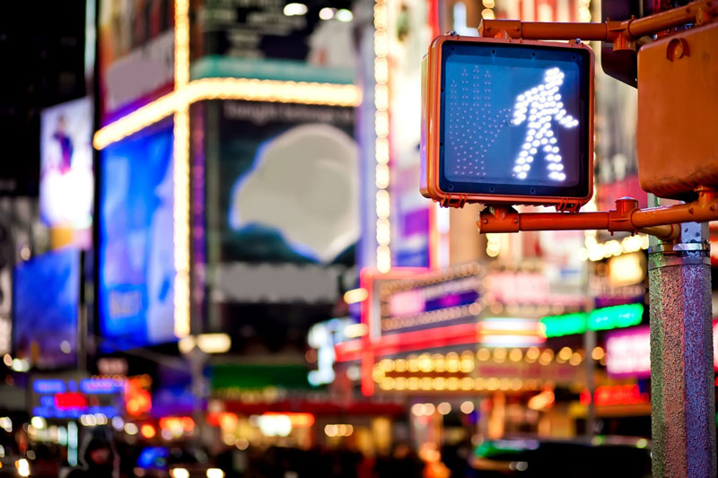 Neon traffic lights on busy street