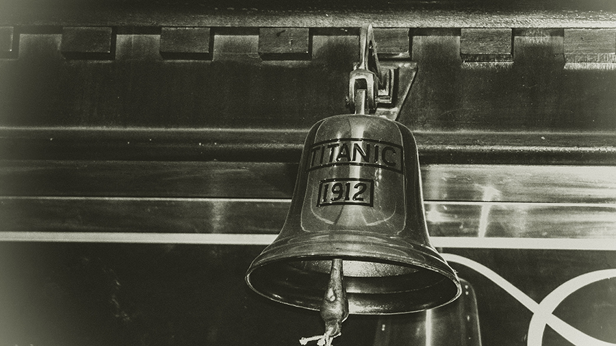 Black and white image of large bell inscribed Titanic 1912