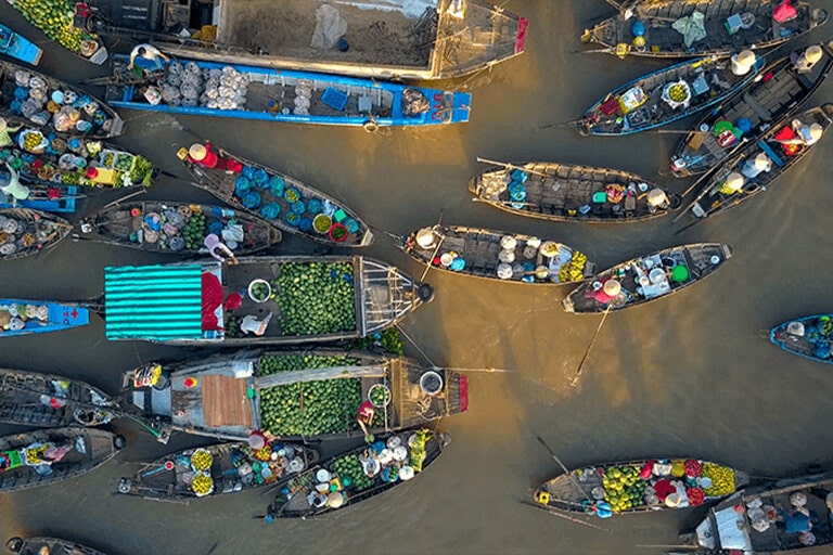Colorful boat vendors at Asian floating market from above