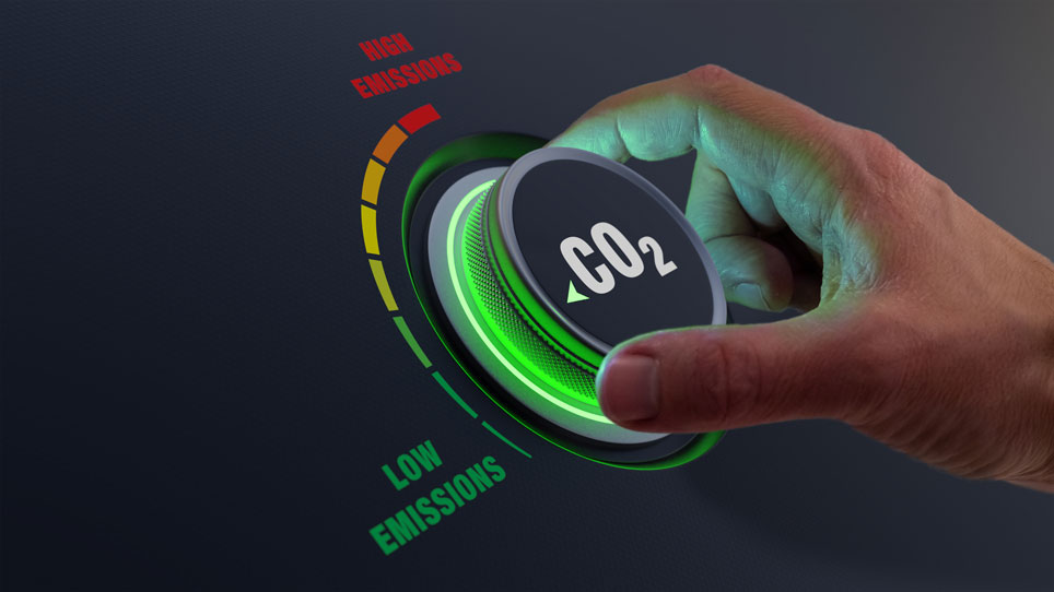 Hand turns up dial on CO2 emissions dashboard