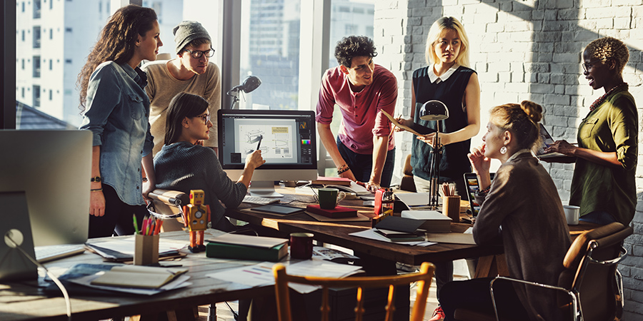 Group of colleagues gather in office during meeting