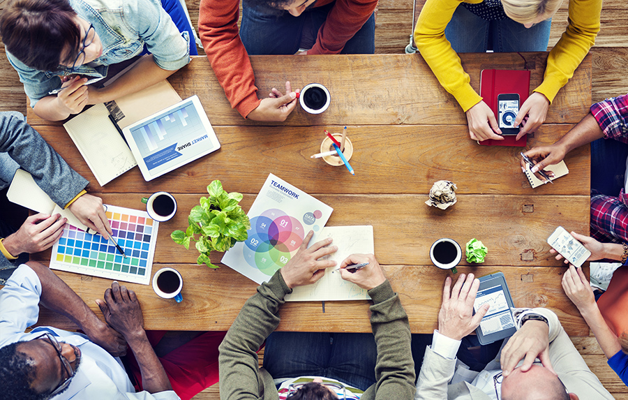 Aerial shot of colleagues having coffee at table