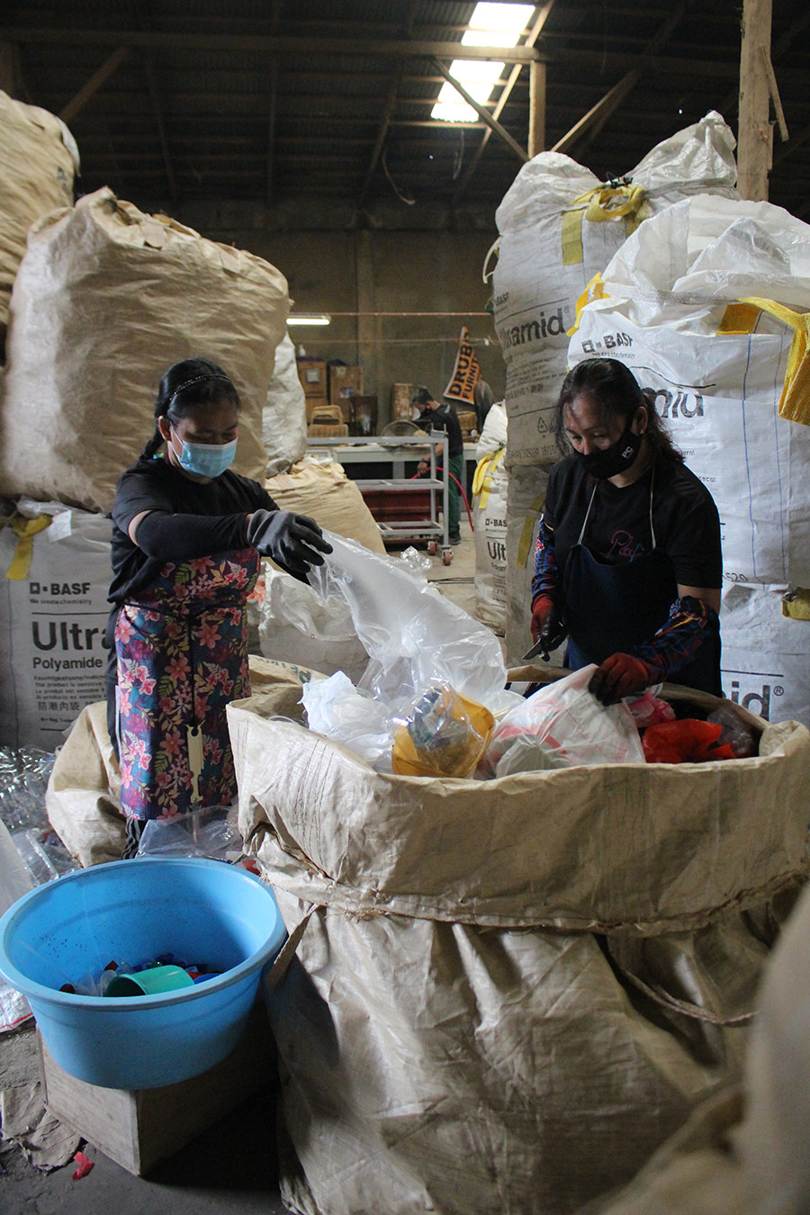 2 Filipino women sort plastic waste