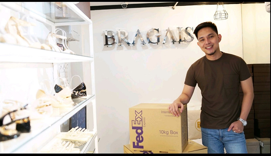 Young Filipino man with FedEx box in shoe studio