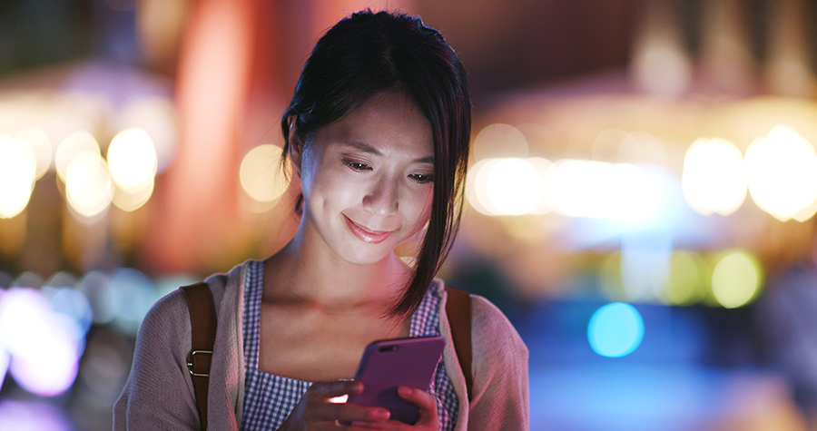 Asian female browsing on smartphone