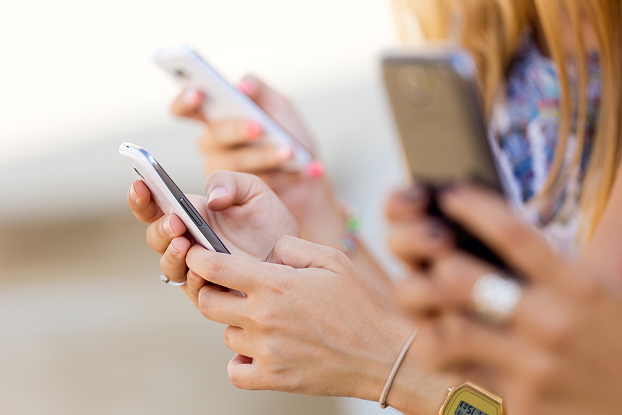 Group of people browsing on their mobile phones