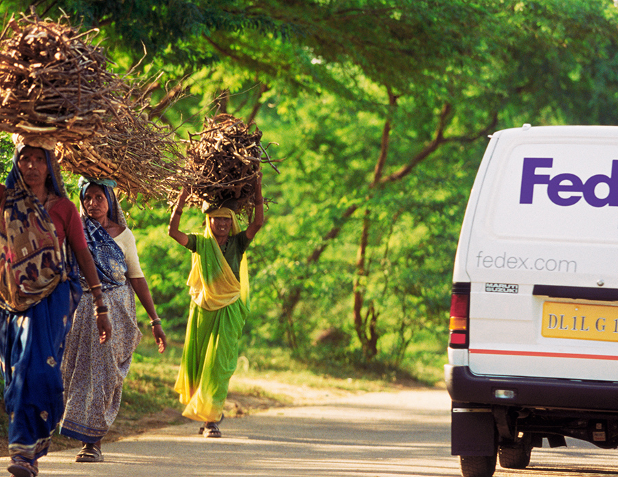 Group of women walk past a FedEx truck