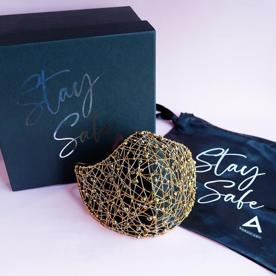 Gold wire mask with Stay Safe logo on box