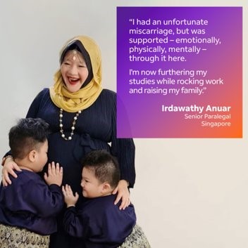 Woman smiles while her two sons hug her