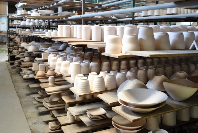 Shelves of whit pottery in porcelain factory