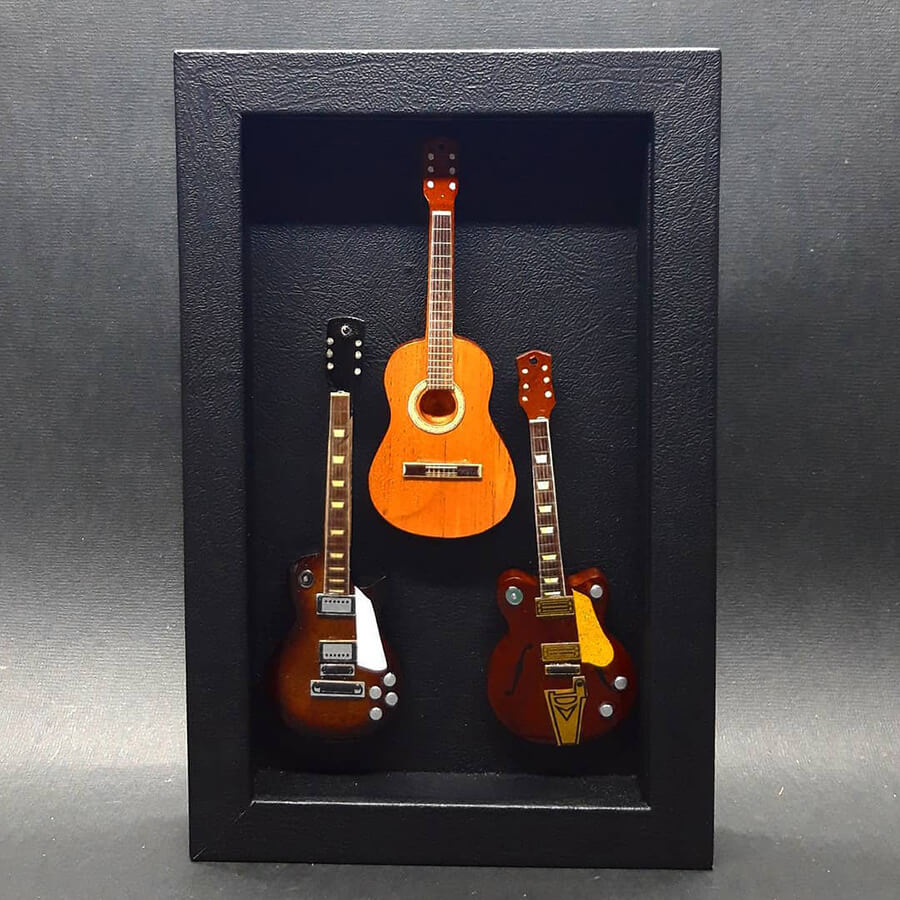 miniature guitars mounted in black display case