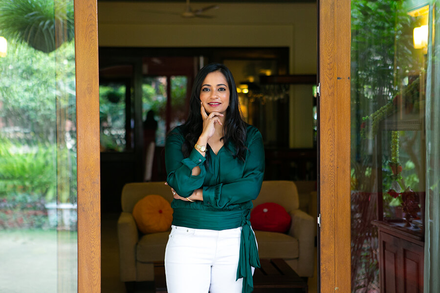 Indian female in green silk shirt standing in doorway