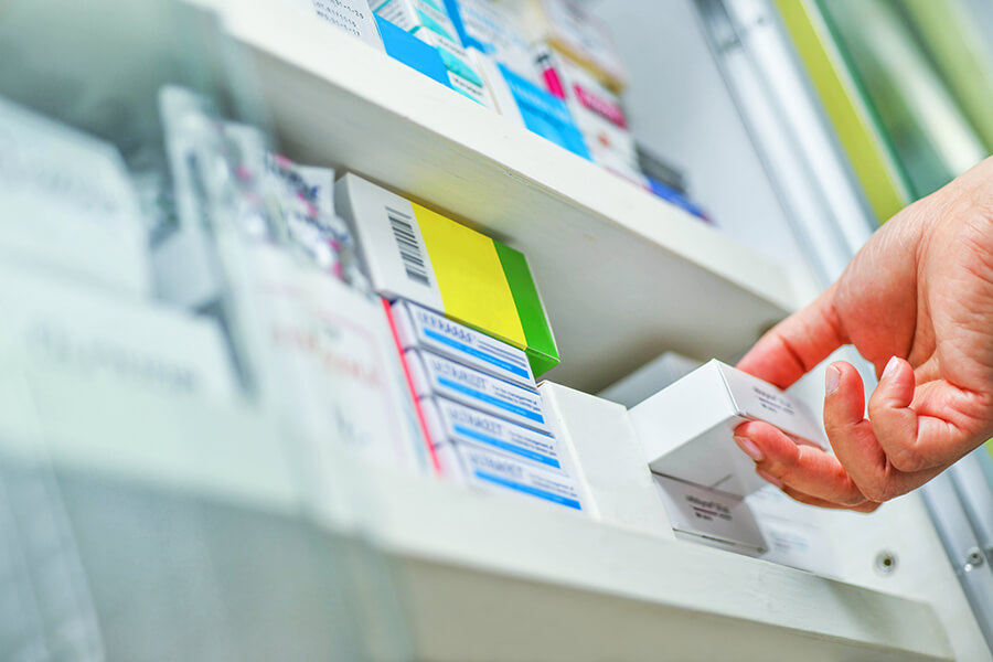 Pharmacist holding medicine box