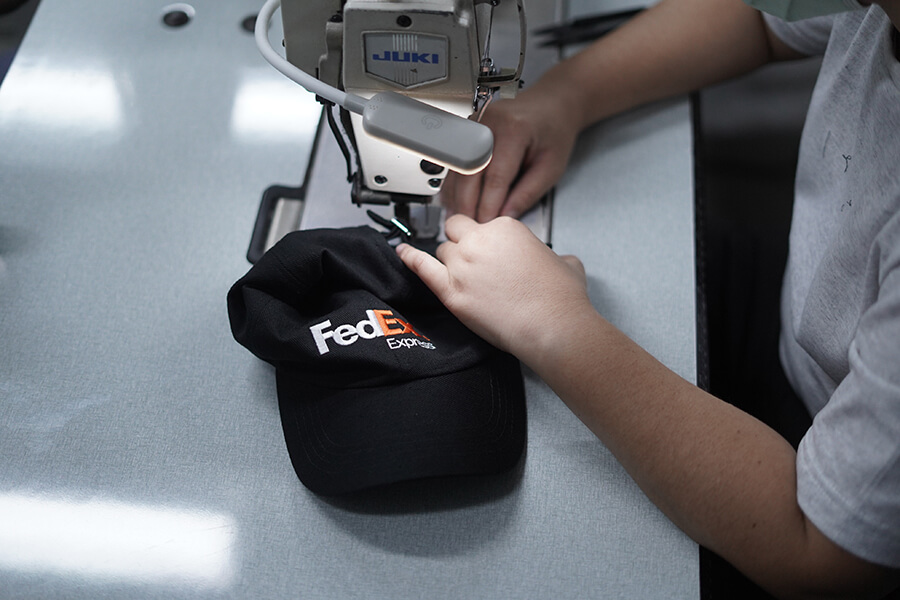 FedEx cap being embroidered with sewing machine