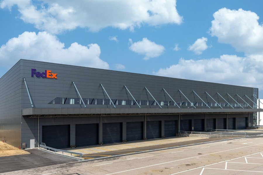 FedEx sorting hub building against blue sky backdrop