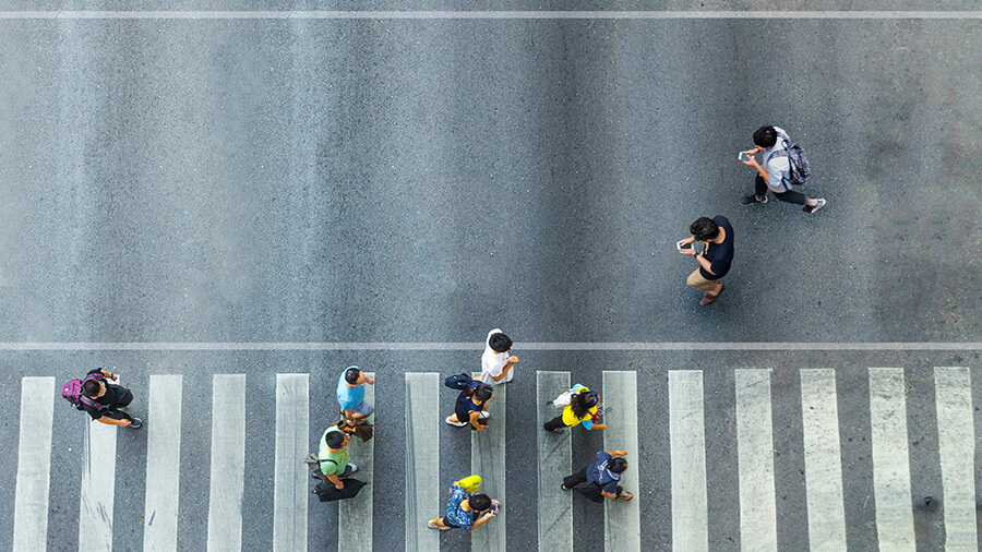 Group of people walking on street pedestrian crossroad