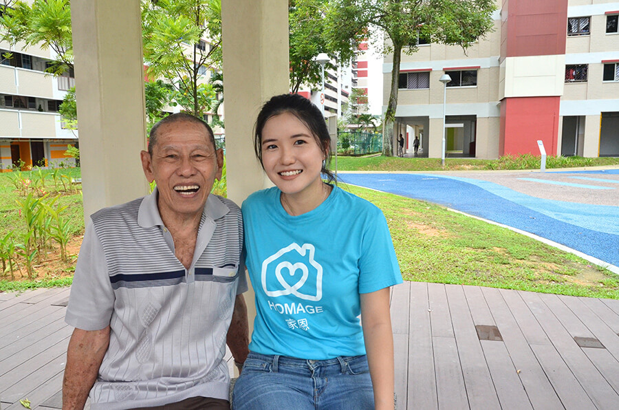 Young Singaporean care worker with elderly Singaporean male