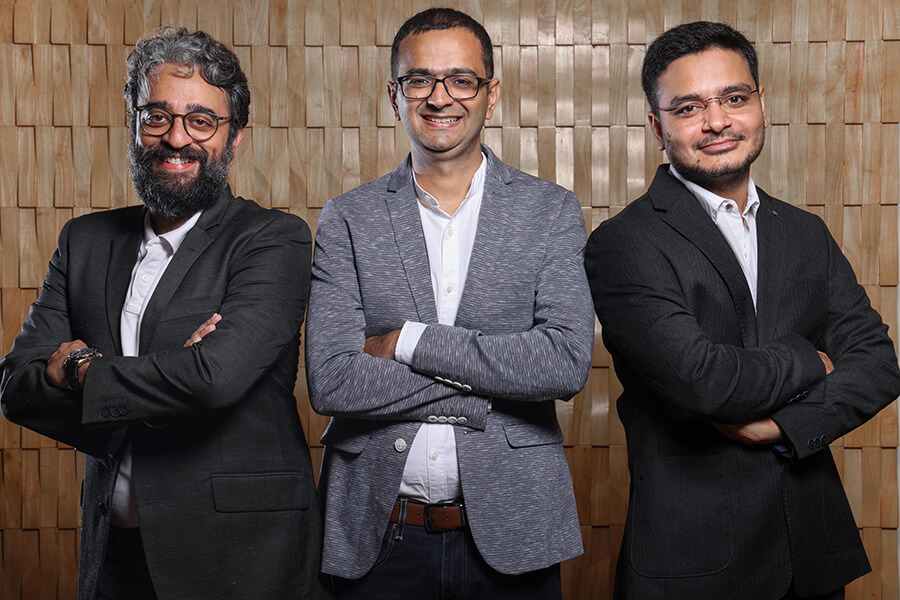 3 Indian males in glasses and business attire