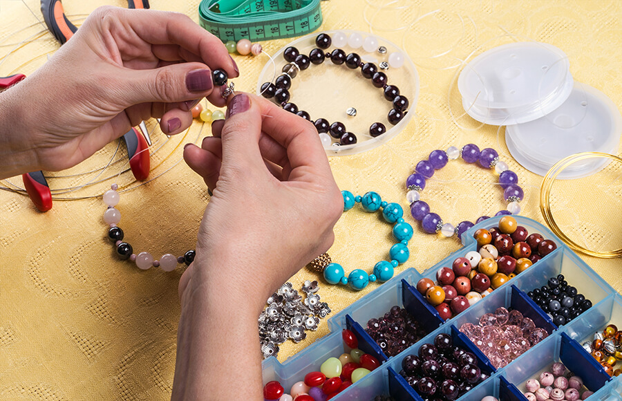 A pair of hands making jewelry