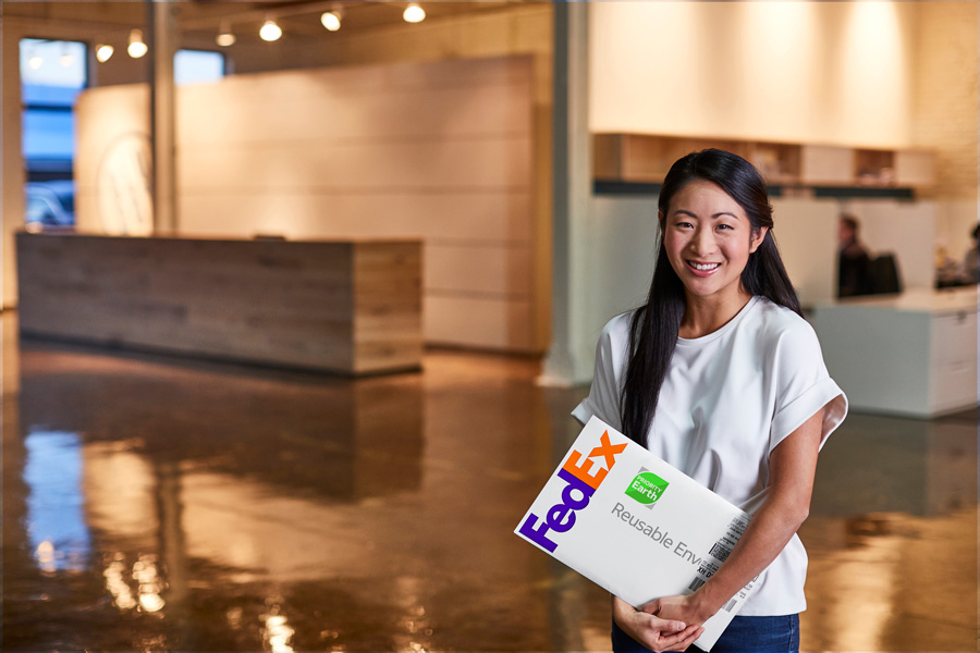 Young-South-Asian-female-smiling-holding-FedEx-packet