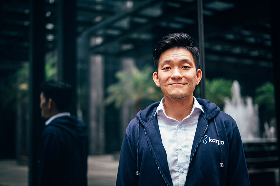 A young man standing and smiling