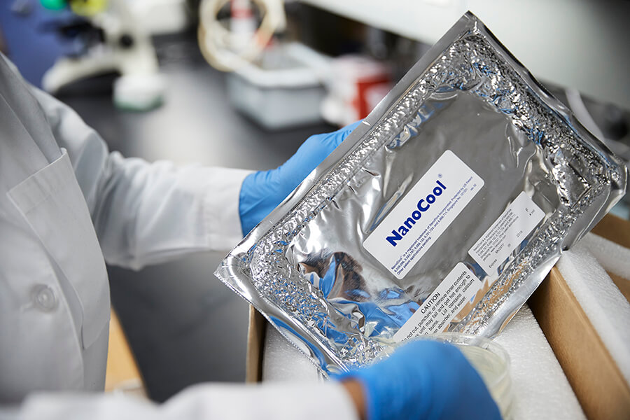 Doctor in white coat holding chemist products in a lab