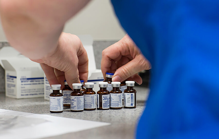 A doctor organizing vaccines in the lab