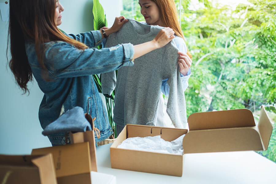 Customers receive shipment of clothes in the mail and tries them on