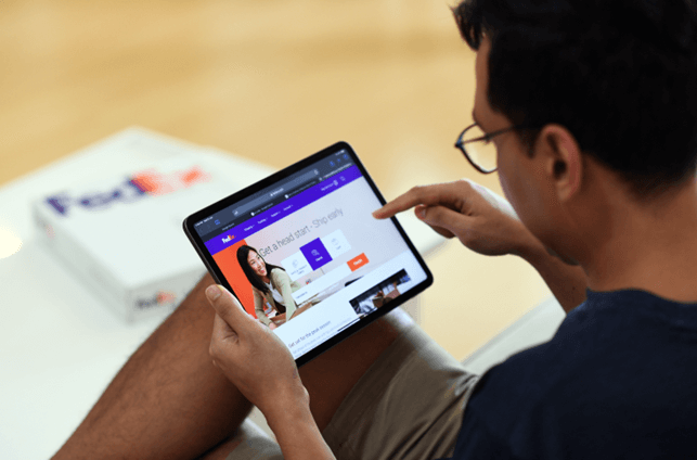 A man browsing FedEx parcel tracking on tablet