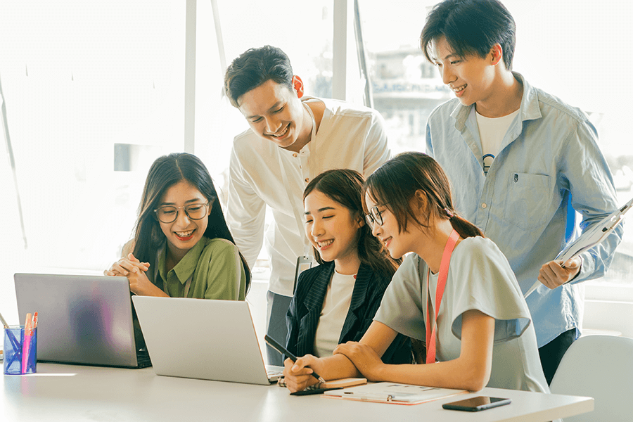 Asian business employees looking at a computer