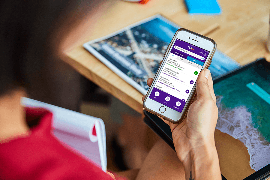Person holding mobile phone using FedEx mobile app