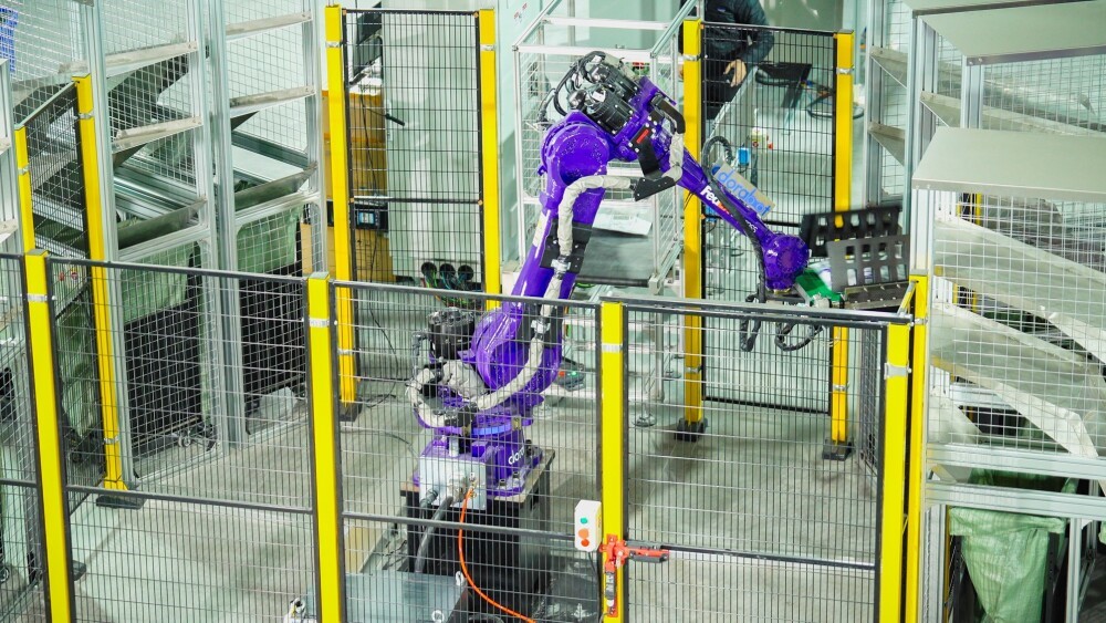 FedEx robotic sorting arm working in a warehouse