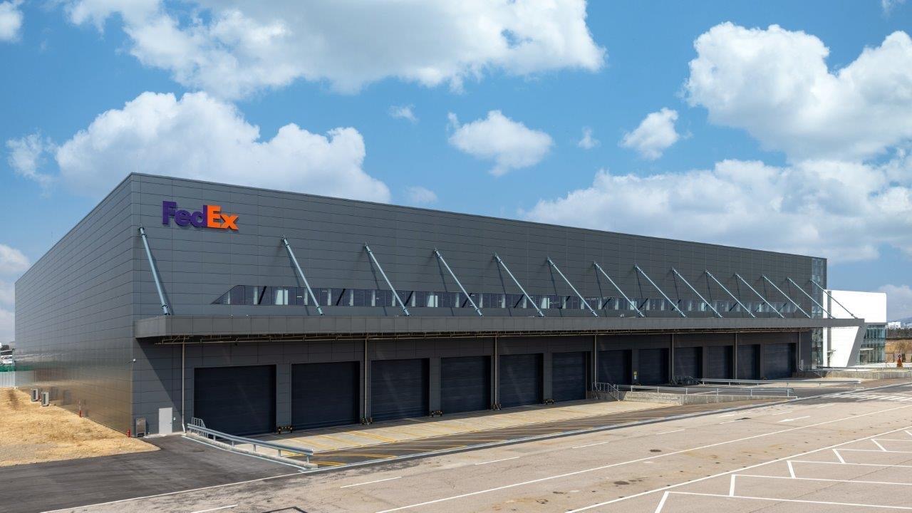 FedEx sorting hub building against blue sky backdrop