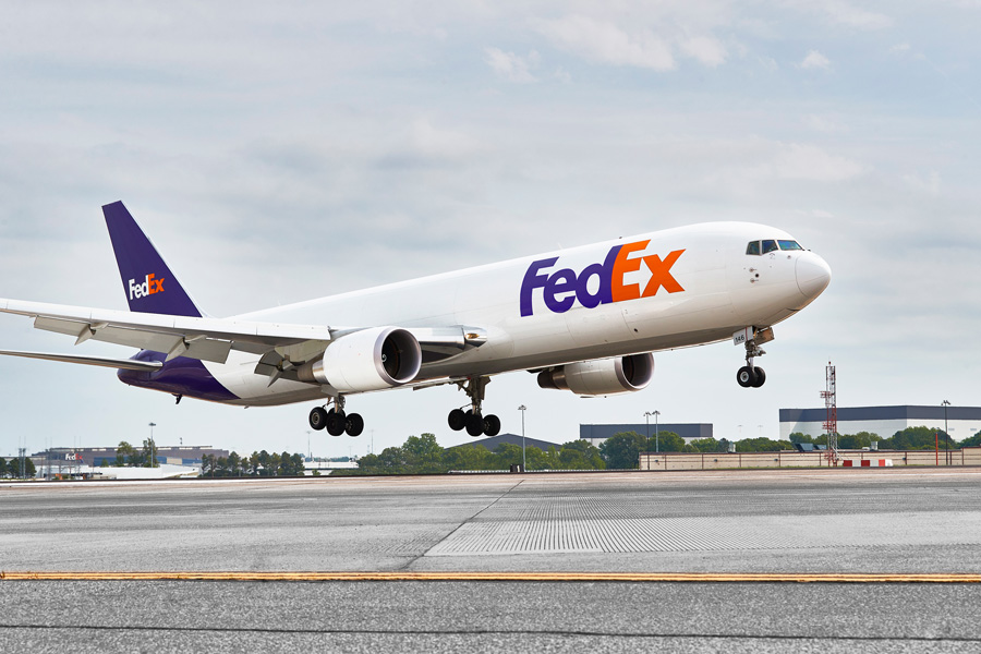 FedEx plane takes off on runway at airport