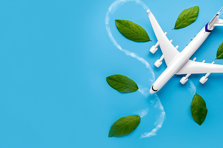 Model plane on sky blue background with swirling green leaves