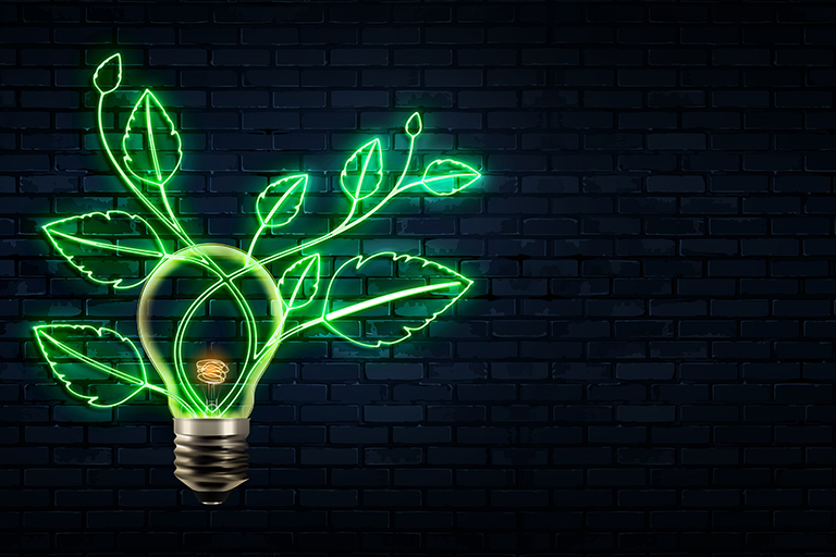 Neon green lightbulb with illuminated leaves