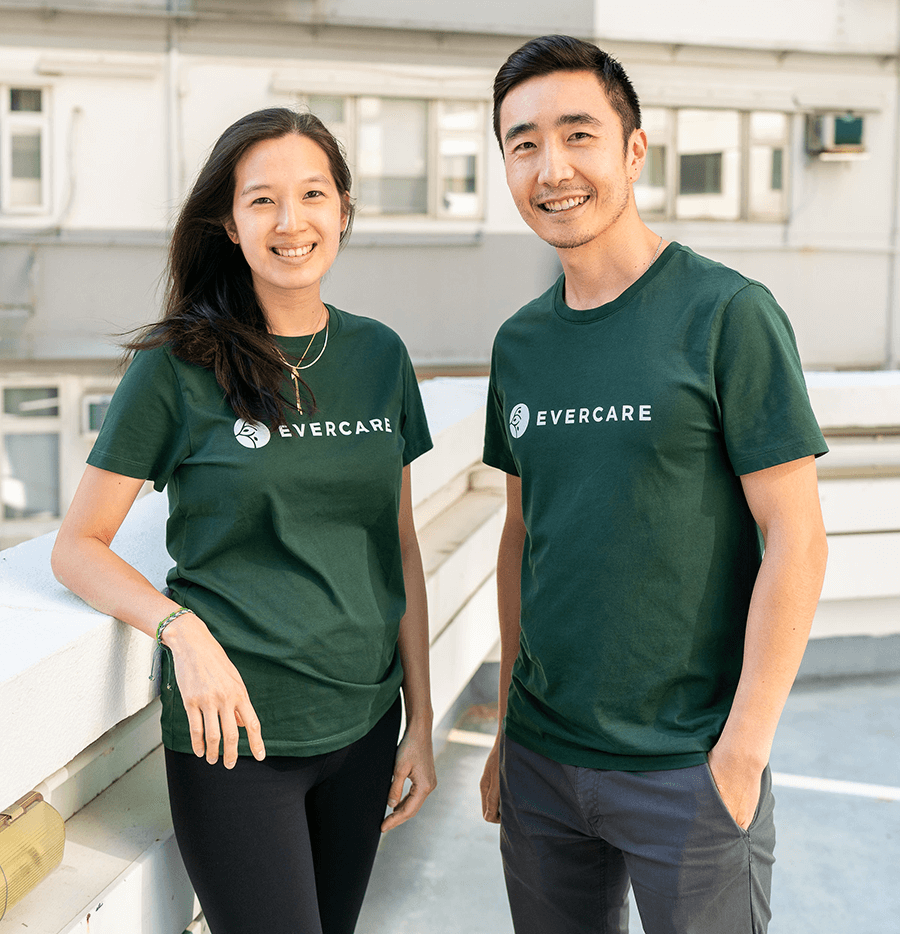 Chinese male and female in green ‘Evercare’ branded t-shirts