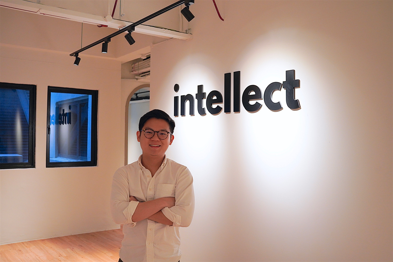 Theodoric Chew, co-founder and CEO of Intellect, smiling with arms folded