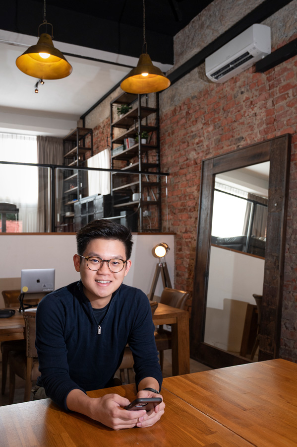 Theodoric Chew, co-founder and CEO of Intellect, sitting in a studio with brick walls