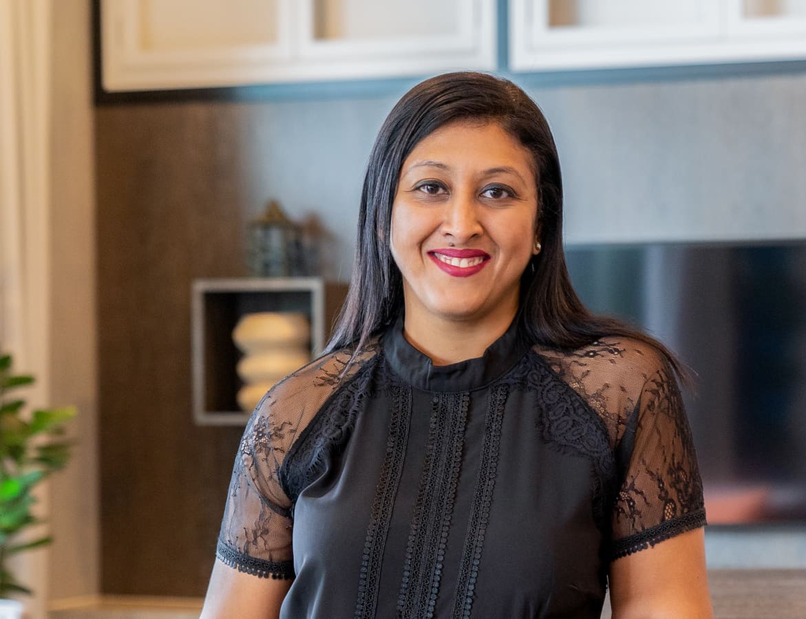 Maya Harri, CEO of Terrascope standing smiling in black lace top