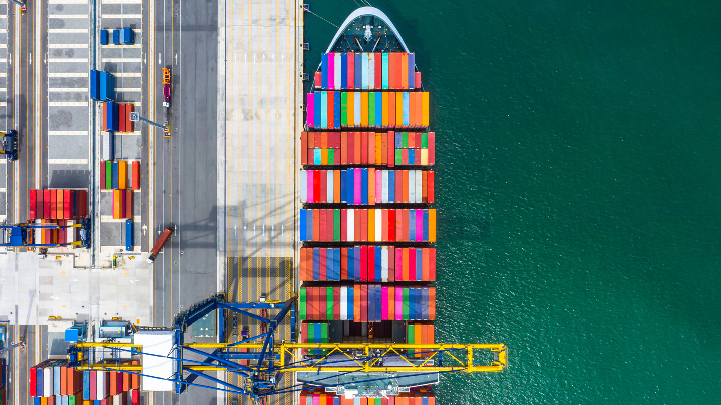 Container ship at sea port loaded with multi-colored shipping containers