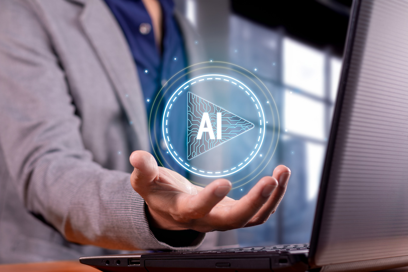 Male professional holds illuminated orb with word ‘AI’