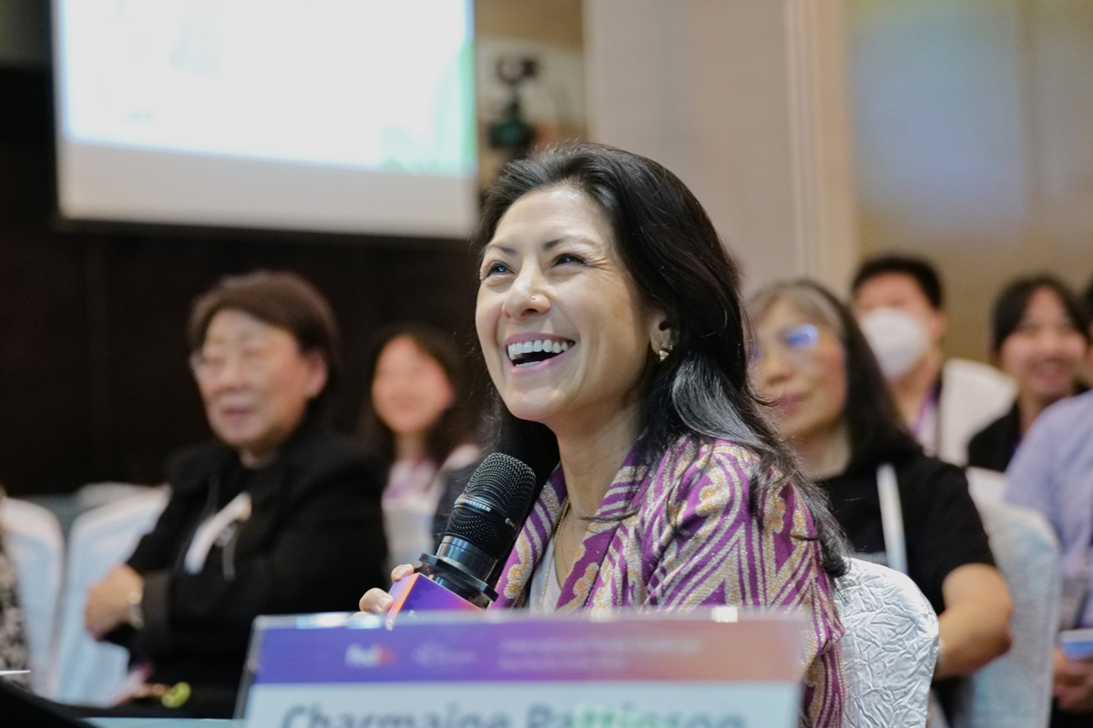 Charmaine Pattinson, CEO of Plinkit, seated in audience at an event with microphone